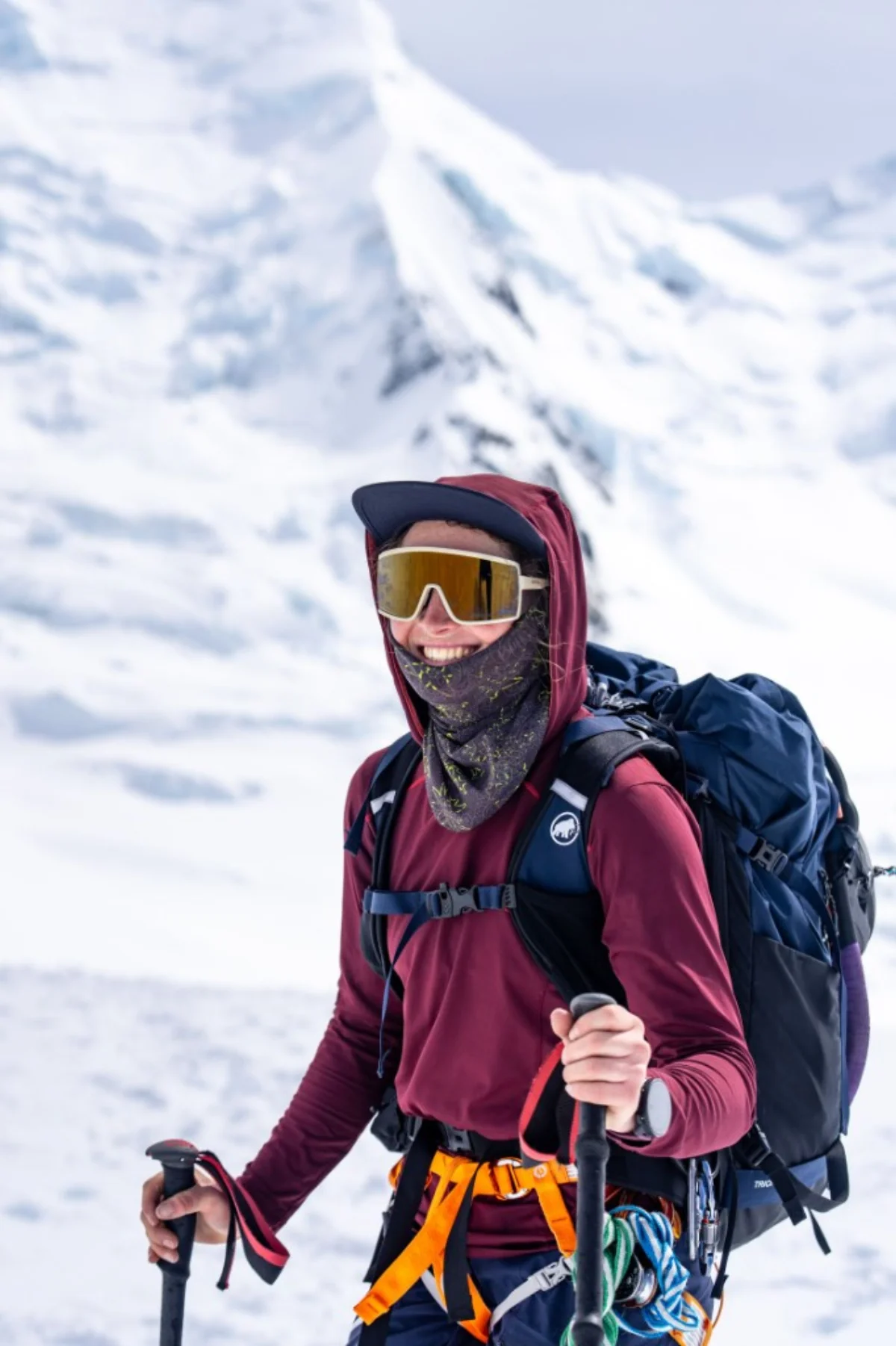 Petrouchka Steiner-Grierson in alpine kit, smiling against snowy mountain peaks